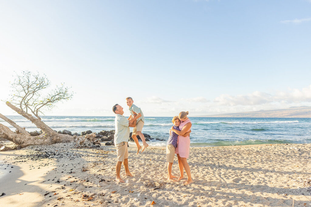 kids playing on the beach at golden hour climbing a tree