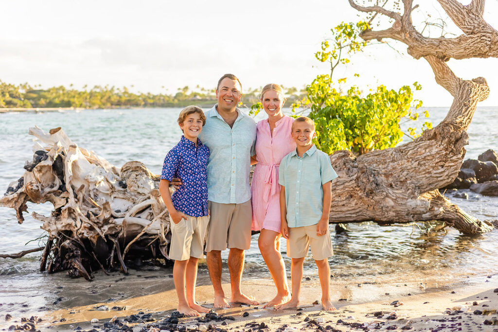 parents and children smiling at mauna lani beach during golden hour