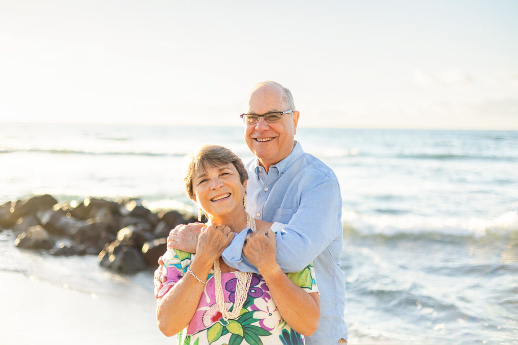 grandma and grandpa smiling at the beach