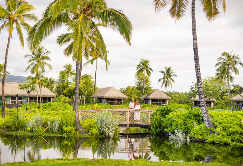 Couple Embracing with Lush Greenery and Villas in the Background